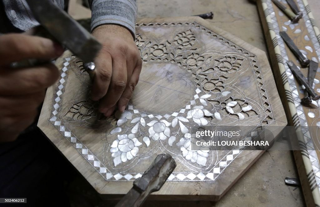 Syria Workshops A Syrian artisan works on wood carving furniture at his workshop in ...