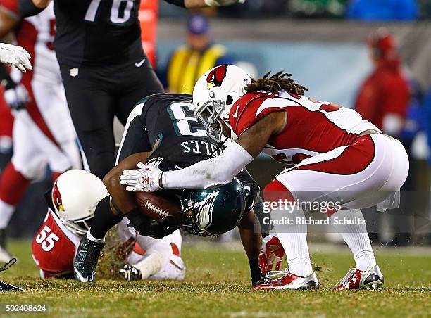 Darren Sproles of the Philadelphia Eagles is tackled by Sean Weatherspoon and D.J. Swearinger of the Arizona Cardinals in the second half at Lincoln...