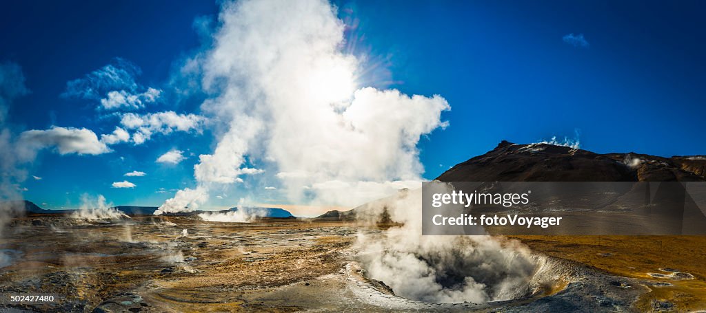 Steam rising from geyser fumarole volcanic lava field panorama Iceland