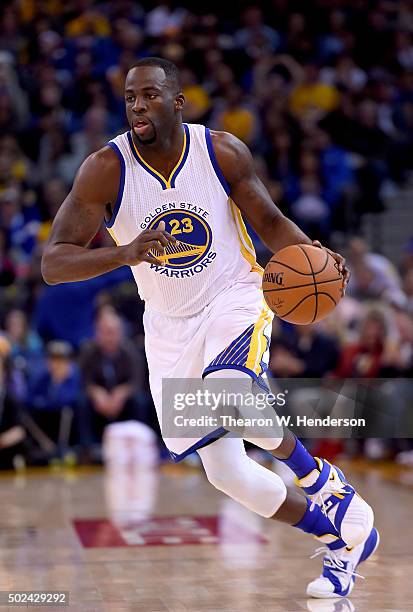 Draymond Green of the Golden State Warriors dribbles the ball against the Utah Jazz during their NBA basketball game at ORACLE Arena on December 23,...