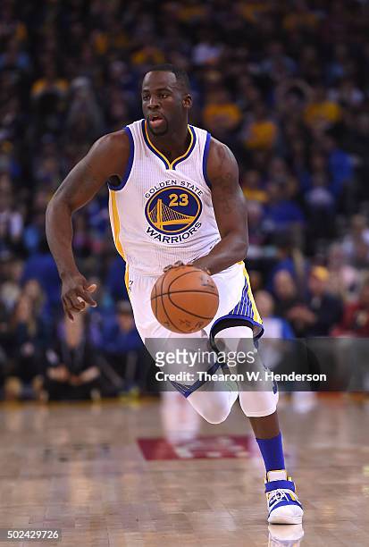 Draymond Green of the Golden State Warriors dribbles the ball against the Utah Jazz during their NBA basketball game at ORACLE Arena on December 23,...