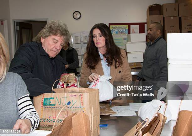 Restaurateurs Ken Todd and wife Lisa Vanderpump package holiday meals for delivery to Project Angel Food clients at Project Angel Food on December...