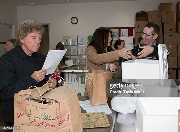 Restaurateurs Ken Todd and wife Lisa Vanderpump package holiday meals for delivery to Project Angel Food clients at Project Angel Food on December...