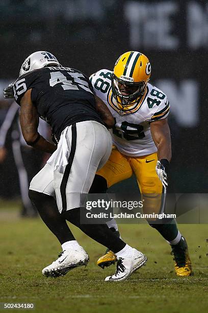 Full back Marcel Reece of the Oakland Raiders is tackled by line backer Joe Thomas of the Green Bay Packers in the fourth quarter at O.co Coliseum on...