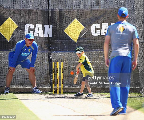 Adam Voges bowls to his son Xavier Voges as head coach Darren Lehmann fields in slips during an Australia nets session at on December 25, 2015 in...