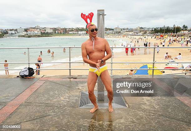 Adrian Lim from Redfern, Sydney, takes a showers down at Bondi Beach on December 25, 2015 in Sydney, Australia. Bondi Beach is a popular tourist...