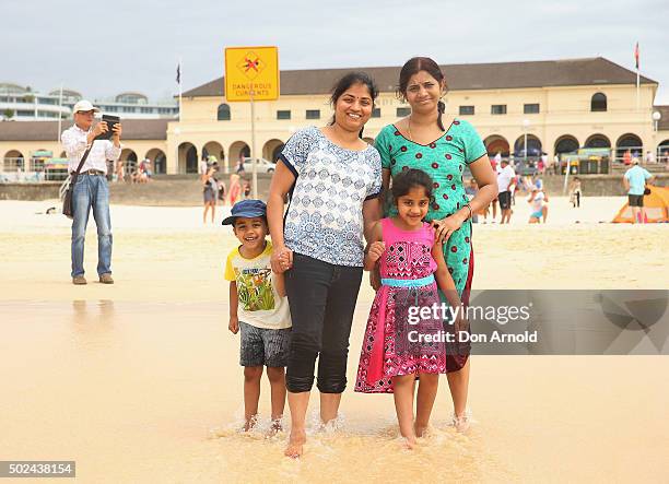 The Alepi family from Hydrabad, India, pose at Bondi Beach on December 25, 2015 in Sydney, Australia. Bondi Beach is a popular tourist destination on...