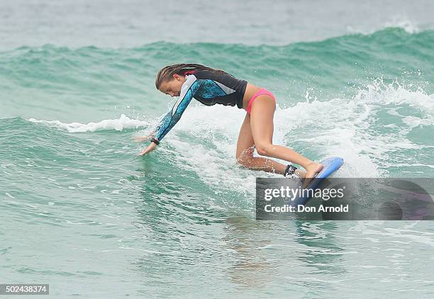 Young girl wipes out at Bondi Beach on December 25, 2015 in Sydney, Australia. Bondi Beach is a popular tourist destination on Christmas Day.