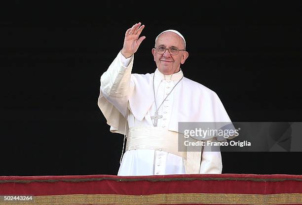Pope Francis waves to the faithful as he delivers his 'Urbi et Orbi' blessing message from the central balcony of St Peter's Basilica on December 25,...