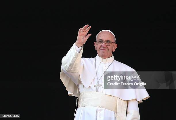 Pope Francis waves to the faithful as he delivers his 'Urbi et Orbi' blessing message from the central balcony of St Peter's Basilica on December 25,...