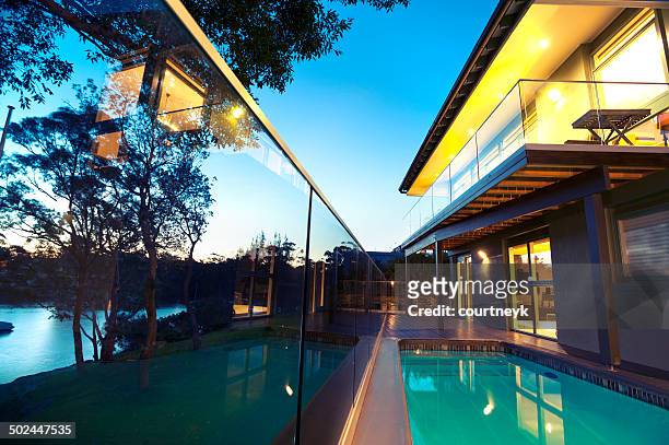 waterfront house with swimming pool - waterfront home stock pictures, royalty-free photos & images