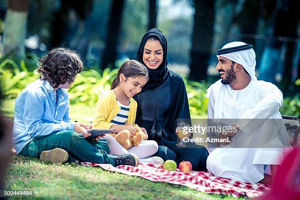 they love sunday afternoons - arab family happy stock pictures, royalty-free photos & images