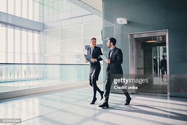 office corridor with elevator during morning rush hour - elevetor photo stock pictures, royalty-free photos & images