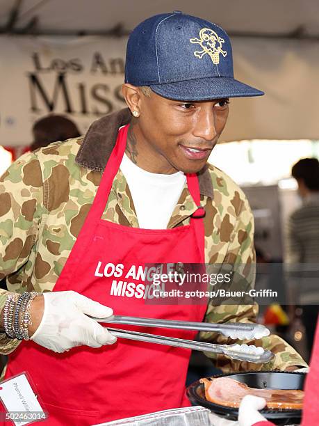 Pharrell Williams is seen at the annual Los Angeles Mission Christmas Dinner on December 24, 2015 in Los Angeles, California.
