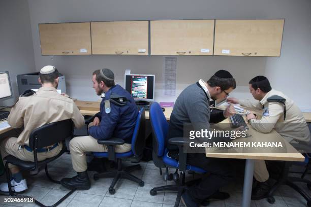 Israeli soldiers of the Shachar Kachol Ultra-Orthodox Jewish unit work in front of computers at their army base in Tel Aviv on December 17, 2015. The...