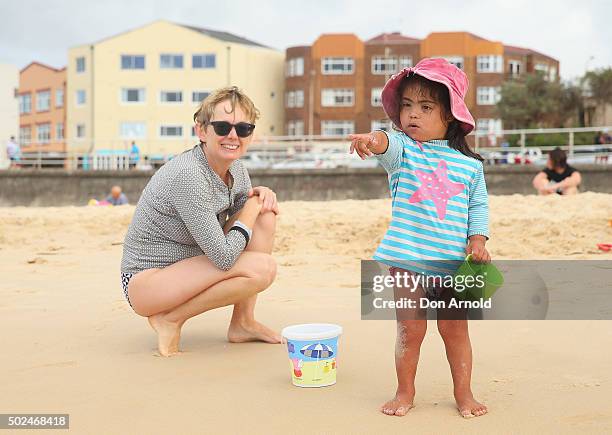 Young girl is watched by her mother as she plays in the sand at Bondi Beach on December 25, 2015 in Sydney, Australia. Bondi Beach is a popular...