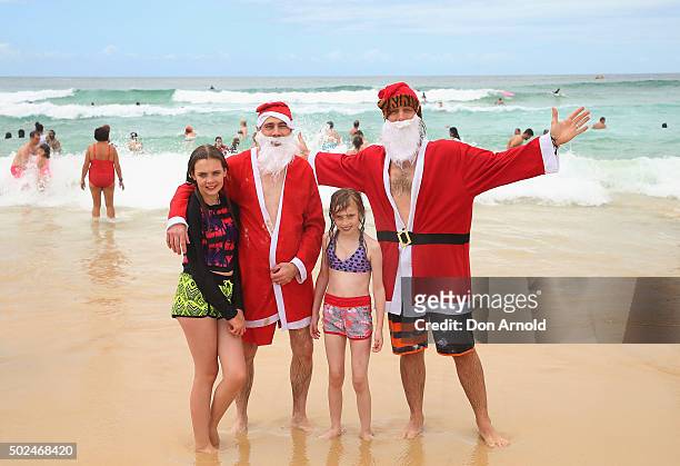 People pose from the surf at Bondi Beach on December 25, 2015 in Sydney, Australia. Bondi Beach is a popular tourist destination on Christmas Day.