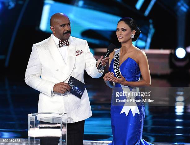 Host Steve Harvey listens as Miss Philippines 2015, Pia Alonzo Wurtzbach, answers a question during the interview portion of the 2015 Miss Universe...