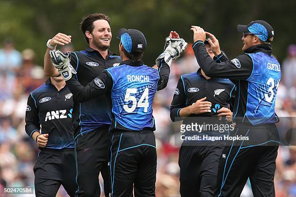 Mitchell McClenaghan and Luke Ronchi of New Zealand celebrate after taking the wicket of Nuwan Kulasekara of Sri Lanka during the first One Day...