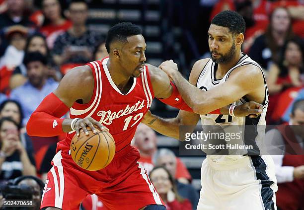 Dwight Howard of the Houston Rockets and Tim Duncan of the San Antonio Spurs battle for the position during their game at the Toyota Center on...