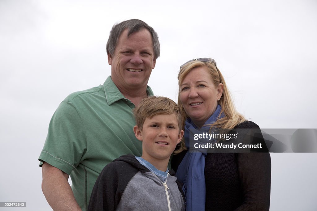 Parents and adolescent son at the beach