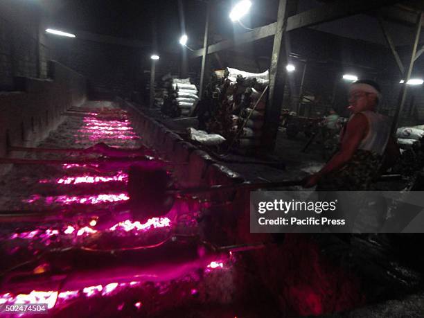 Filipino worker handles roasted pig cooked in bamboo rotiserries at suburban Quezon City, east of Manila, Philippines. Roasted pig, locally called...