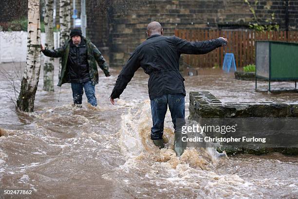 Residents battle against floodwater as the River Calder bursts its bank's in the Calder Valley town of Mytholmroyd on December 26, 2015 in...
