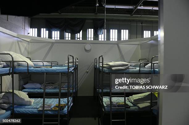Temporary bedrooms are pictured at a refugee accomodation hosted in the hangar two of the former Tempelhof airport in Berlin on December 26, 2015. /...