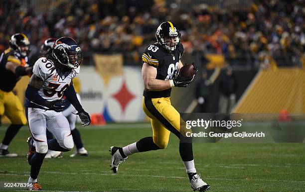 Tight end Heath Miller of the Pittsburgh Steelers runs with the football after catching a pass as he is pursued by safety David Bruton, Jr., of the...