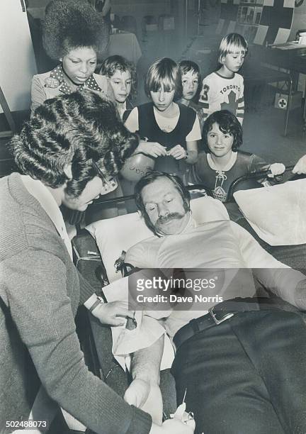 Eddie Shack gives blood. Toronto Maple Leafs' winger Eddie Shack; giving blood at the Red Cross clinic in St. Gabriel's Centre yesterday; said that...