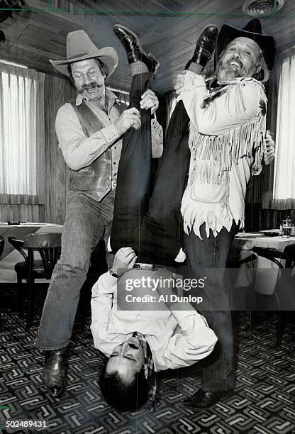 Shakedown: Former Maple Leaf Eddie Shack; left; and country music star Ronnie Hawkins shake the change from the pockets of Kinsman Ernie British....