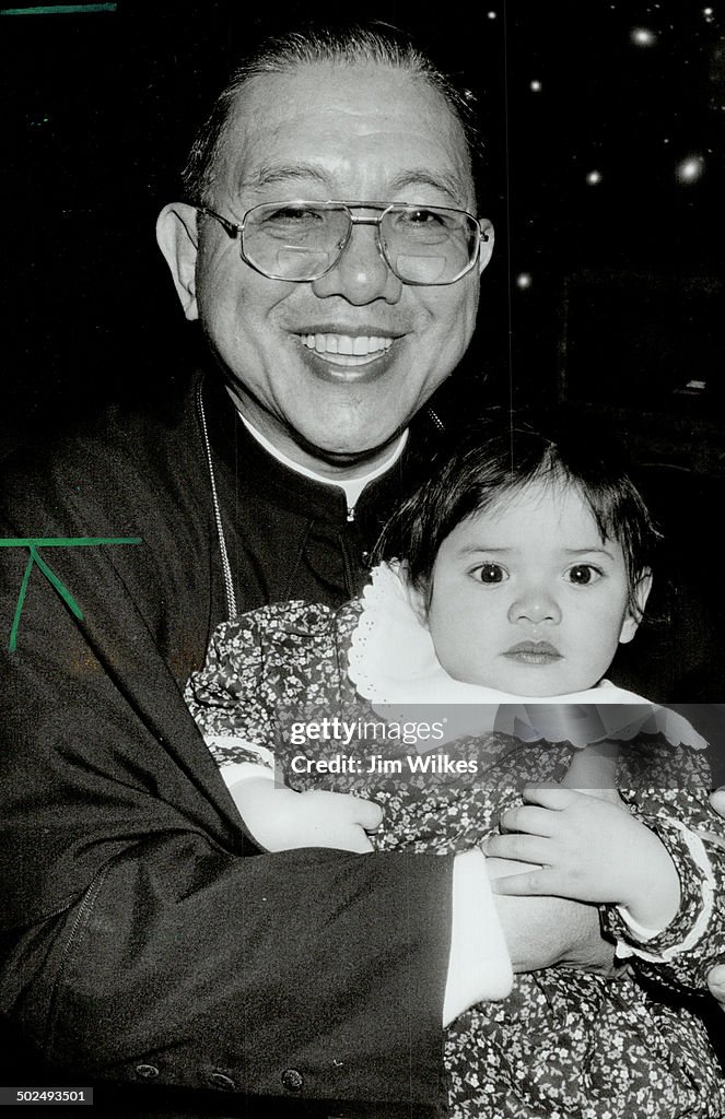 Cardinal Blessing: Jaime Cardinal Sin holds Melissa Bantug; 1; at a Christmas party put on by Metro-