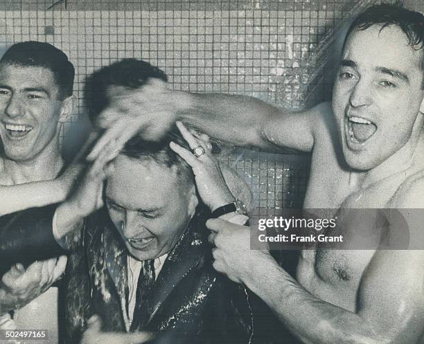 Into the shower goes Stafford Smythe as jubilant Toronto players whoop it up by dousing the Maple Leafs president. Although he was wearing a new suit...