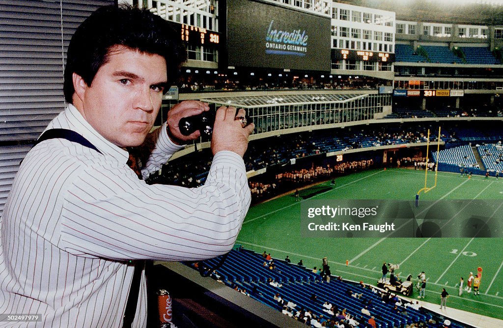 Eye on fans: Argo general manager Mike McCarthy in SkyDome box checks out viewers under glass in res