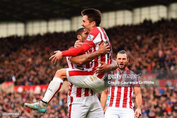Bojan Krkic of Stoke City celebrates with team-mates, including Marko Arnautovic of Stoke City, after scoring the opening goal during the Barclays...