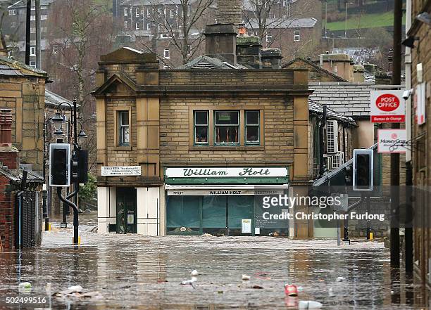 Floodwaters surge around the William Holt store as rivers burst their banks on December 26, 2015 in Hebden Bridge, England. There are more than 200...
