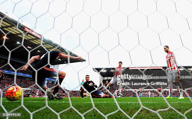 Bojan Krkic of Stoke City scores the opening goal past Chris Smalling and Phil Jones of Manchester United during the Barclays Premier League match...