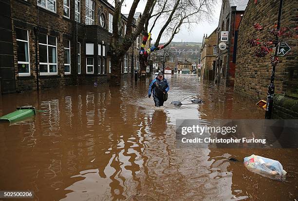 Man wades through floodwaters as rivers burst their banks on December 26, 2015 in Hebden Bridge, England. There are more than 200 flood warnings...