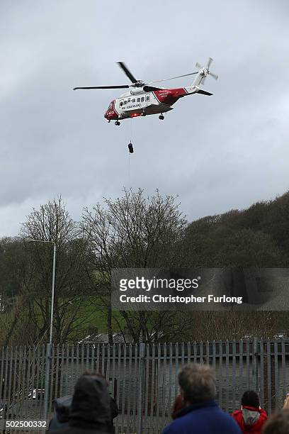 Coastguard helicopter carries out an operation as floodwaters rise after rivers burst their banks on December 26, 2015 in Mytholmroyd, England. There...