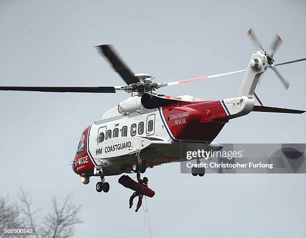 Coastguard helicopter carries out a rescue operation as floodwaters rise after rivers burst their banks on December 26, 2015 in Mytholmroyd, England....