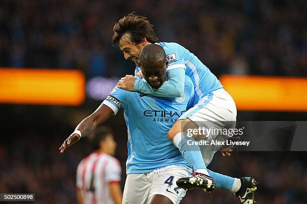 Yaya Toure of Manchester City is congratulated by teammate David Silva after scoring his team's second goal during the Barclays Premier League match...