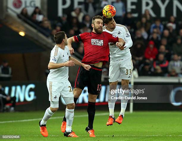 Rickie Lambert of West Bromwich Albion is challenged by Federico Fernandez of Swansea City during the Barclay's Premier League match between Swansea...