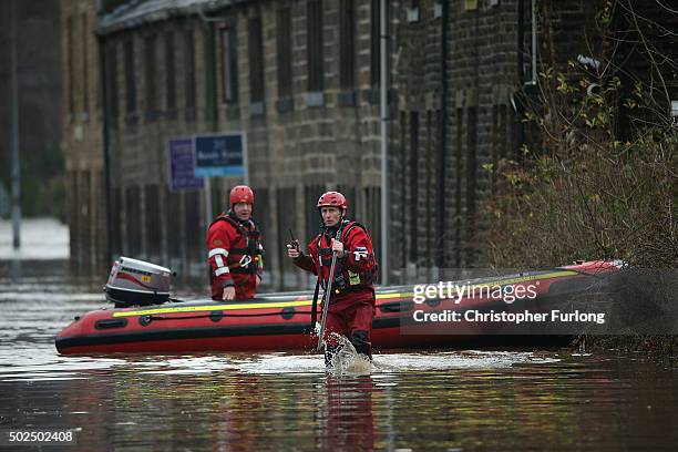 Rescue workers patrol the waters after the River Calder bursts its bank's on December 26, 2015 in Mytholmroyd, England. There are more than 200 flood...