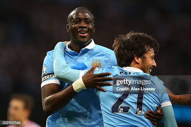 Yaya Toure of Manchester City is congratulated by teammate David Silva after scoring his team's second goal during the Barclays Premier League match...