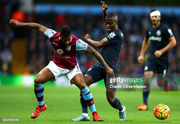 Leandro Bacuna of Aston Villa battles for the ball with Enner Valencia of West Ham United during the Barclays Premier League match between Aston...