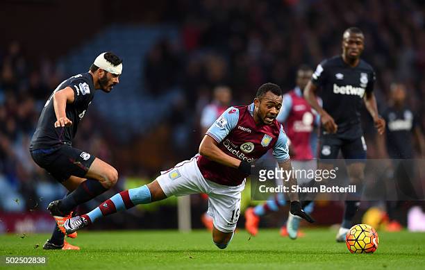 Jordan Ayew of Aston Villa is tackled by James Tomkins of West Ham United during the Barclays Premier League match between Aston Villa and West Ham...