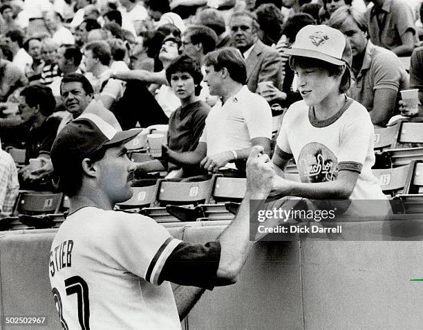 My hero: A young Blue Jays fan sporting his favorite team's cap gets an autograph from his favorite pitcher; Dave Stieb; before yesterday's game....