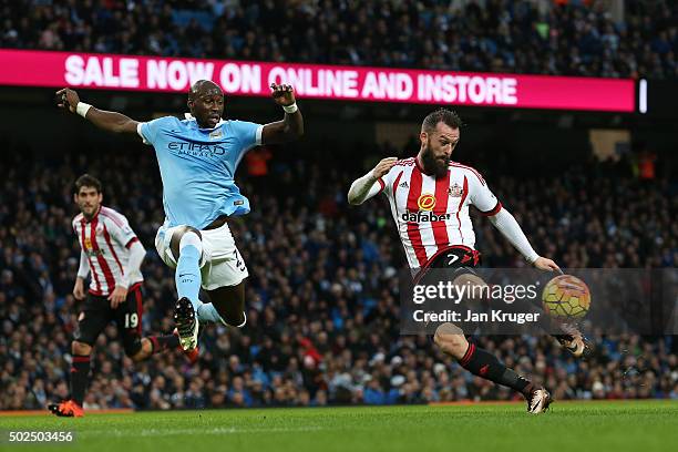 Steven Fletcher of Sunderland takes a shot on goal under pressure from Eliaquim Mangala of Manchester City during the Barclays Premier League match...