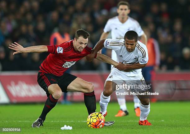 Jonny Evans of West Bromwich Albion and Wayne Routledge of Swansea City battle for the ball during the Barclays Premier League match between Swansea...