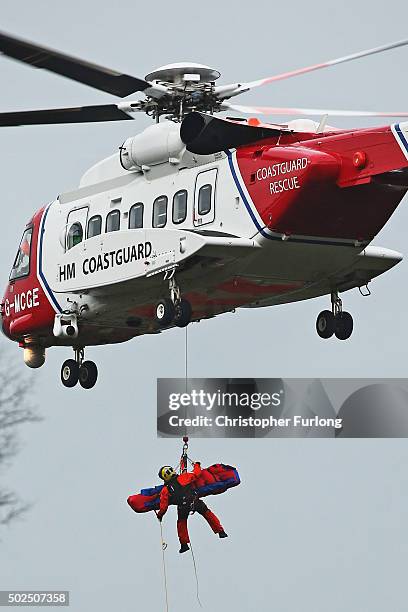 Coastguard helicopter carries out a rescue operation as floodwaters rise after rivers burst their banks on December 26, 2015 in Mytholmroyd, England....